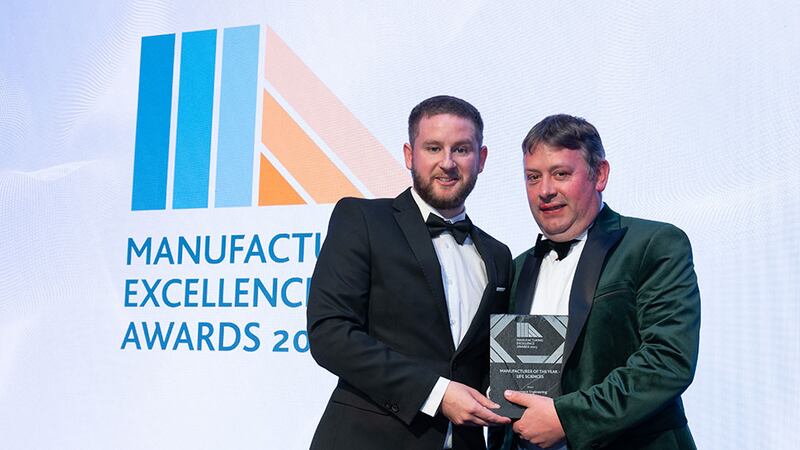 Adam Kane, community lead at Business River, presents the manufacturer of the year - life sciences award to Anthony McKeon, Lawrence Engineering