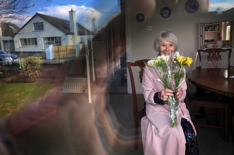 1st Portrait: COCOONING ON MOTHER’S DAY: Ellen Creed, Dublin, with the flowers her daughter left outside her door for Mother’s Day.  Photograph: Bryan O’Brien / The Irish Times