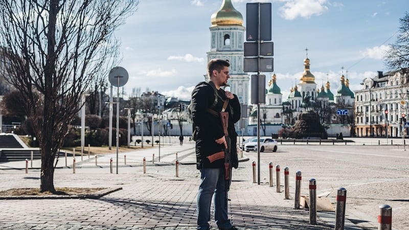 A civilian holds a Kalashnikov rifle in Kyiv on Saturday: thousands have signed up to join Ukraine’s territorial defence force and taken weapons given out by the authorities. Photograph: Diego Herrera/Europa Press via Getty Images
