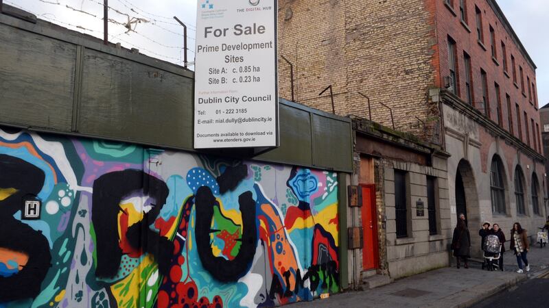 A mural on the wall outside the Brú Aimsir emergency hostel (entrance in orange towards right). Passersby described how a piece of stone facade “around the length of a garden bench” fell from above the entrance into the street on Thursday afternoon last. Photograph: Cyril Byrne/The Irish Times