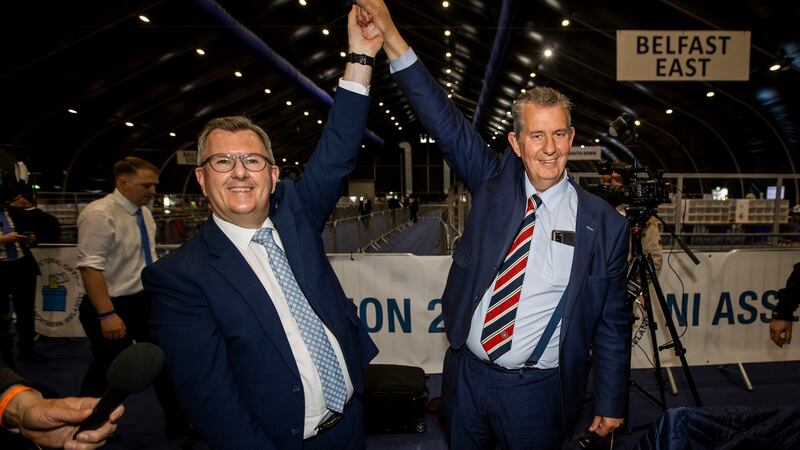 DUP leader Jeffrey Donaldson (left) raises the hand of elected colleague Edwin Poots during the count for the Northern Ireland Assembly Election. Photograph: Liam McBurney/PA